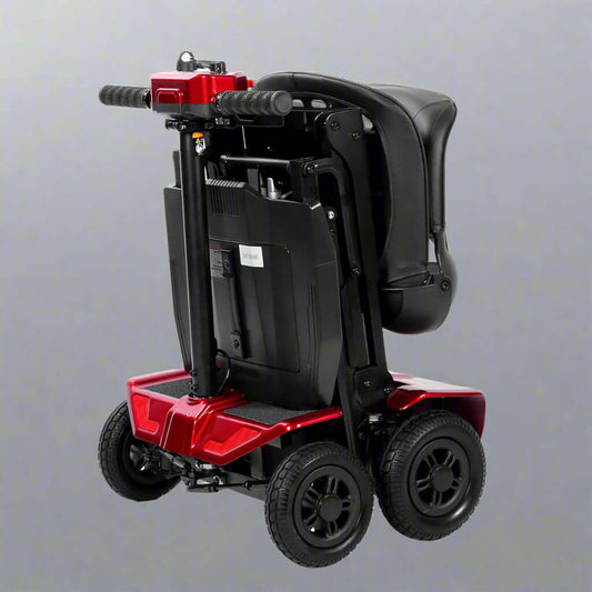 A compact, fully folded MS211AF Electric Mobility Scooter showcasing its portable design. The folded frame, black leather seat, and solid tires are neatly collapsed.