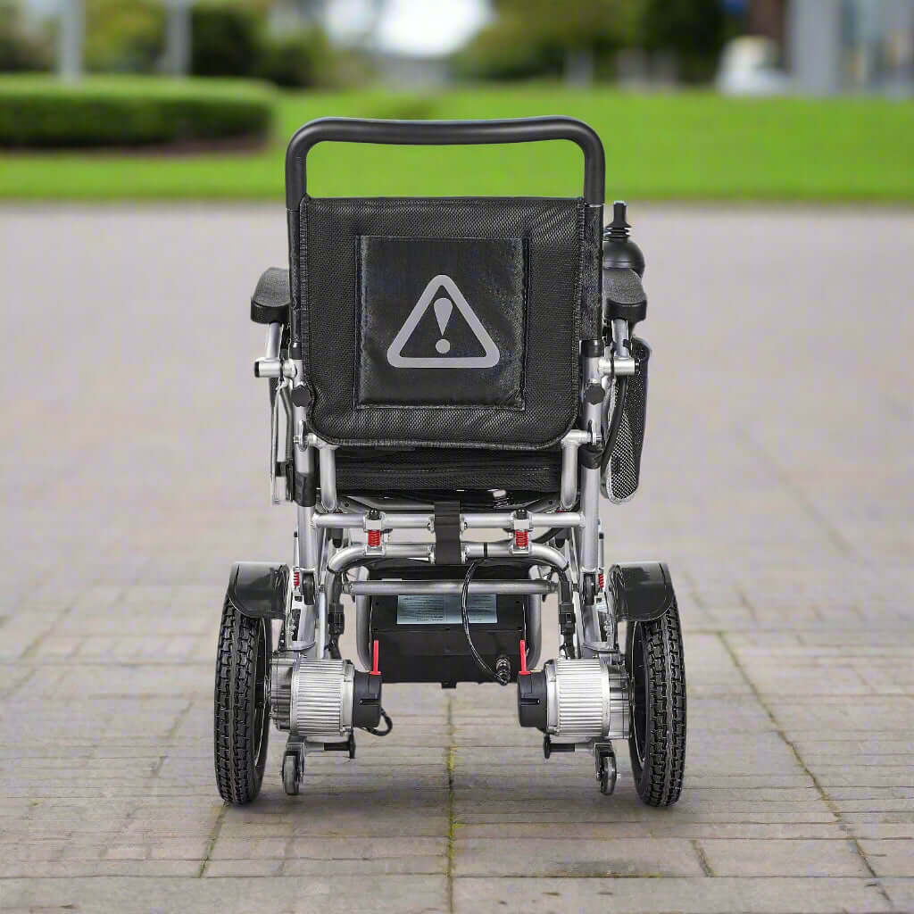 Rear view of the wheelchair showing anti-tip wheels and compact frame structure for stability and safety.