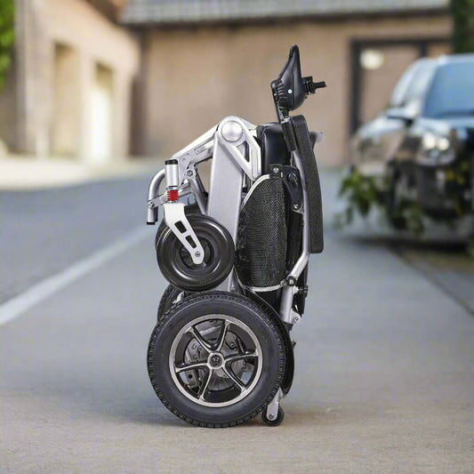 MW9000 foldable electric wheelchair, completely folded and compact, ready for storage or transport in a car.
