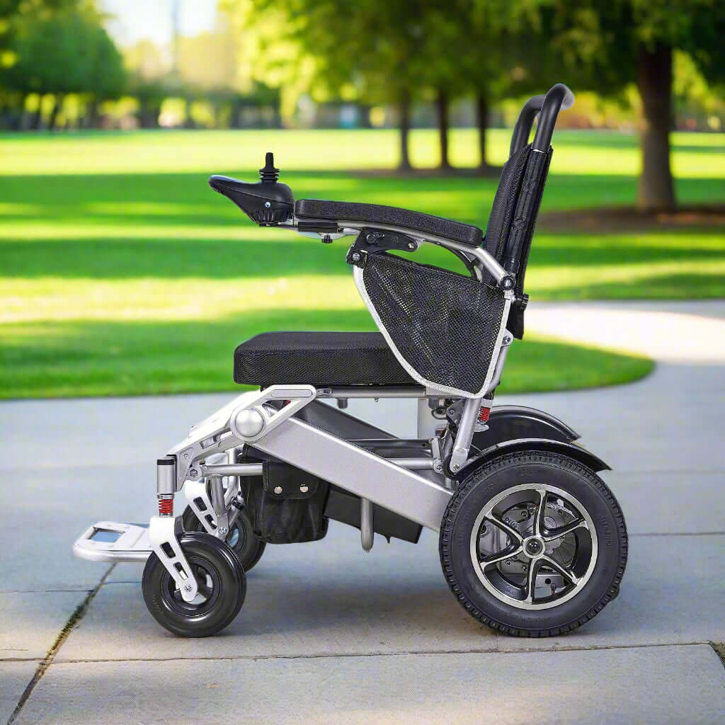 The MW9000 Electric Wheelchair on a paved park pathway. The 12-inch pneumatic rear wheels and 8-inch solid front wheels ensures a smooth ride.